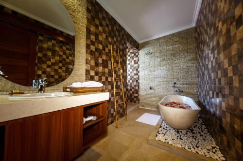 a bathroom with a sink and a bath tub at Villa Suzuki 1 Seminyak in Seminyak