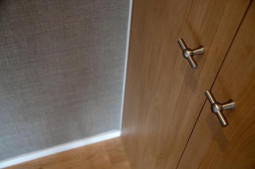 a wooden door with two metal handles in a bathroom at Houseboat Little Amstel in Amsterdam
