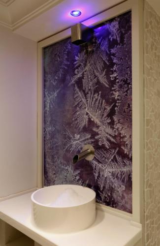 a bathroom with a sink and a painting on the wall at Villa Silva - Oberhof in Oberhof