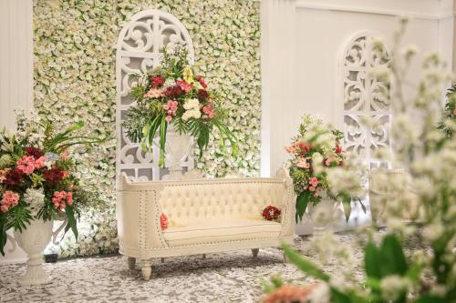 a room with flowers in vases on a wall at Novotel Semarang in Semarang