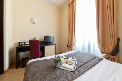 a hotel room with a tray of food on a bed at Hotel Naples in Naples