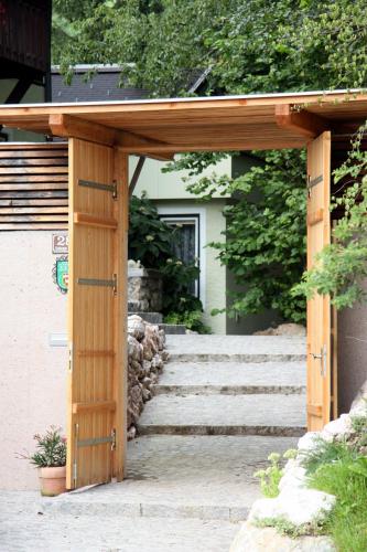 a wooden entrance to a house with a wooden pergola at Landhaus Mooslechner in Radstadt