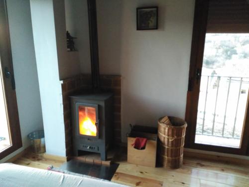 a living room with a wood stove in a room at El Pretil del Olmo in Cuenca