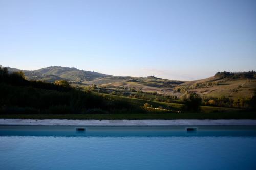 a large body of water with mountains in the background at Locanda Palazzone in Orvieto