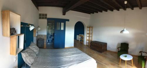 a room with a bed with a sheet on it at El Pretil del Olmo in Cuenca