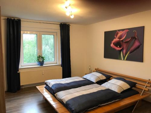 a bedroom with two beds and a window at An der Weissen Mauer 14 Ferienwohnung 1 u 2 in Görlitz