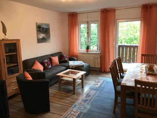 a living room with a couch and a table at An der Weissen Mauer 14 Ferienwohnung 1 u 2 in Görlitz