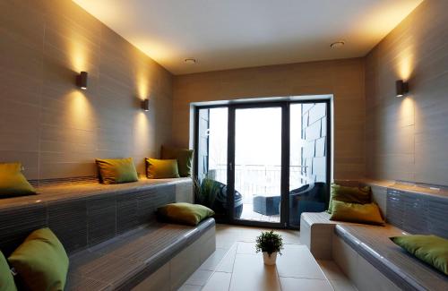 a room with two benches and a large window at Konsum Berghotel Oberhof in Oberhof