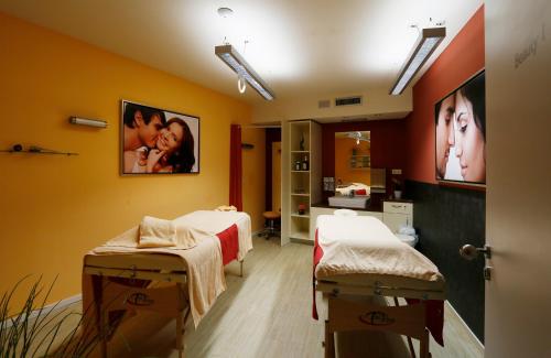a hospital room with two beds and pictures on the wall at Konsum Berghotel Oberhof in Oberhof