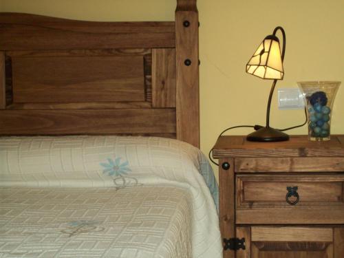 a bedroom with a bed and a lamp on a night stand at El Salat, alojamientos rurales in Guadalest