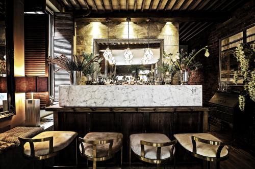 a bar with chairs and a counter in a room at The Cow Hollow Hotel in Manchester