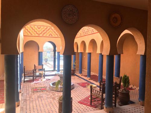 a room with columns and arches in a building at Kasbah Rayane Ait Ben Haddou in Aït Ben Haddou