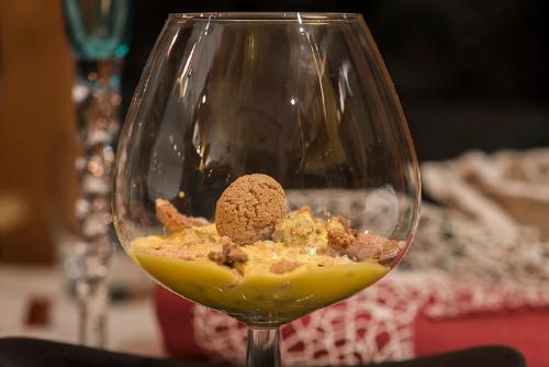 a wine glass with a piece of food in it at El Patio Hotel in Corciano