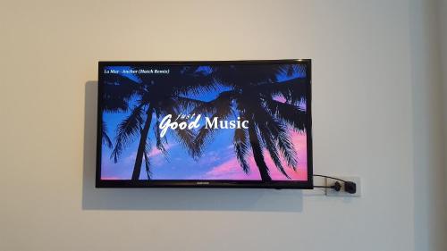 a flat screen tv hanging on a wall at Haus Sathorn 21 Bed and Breakfast in Bangkok