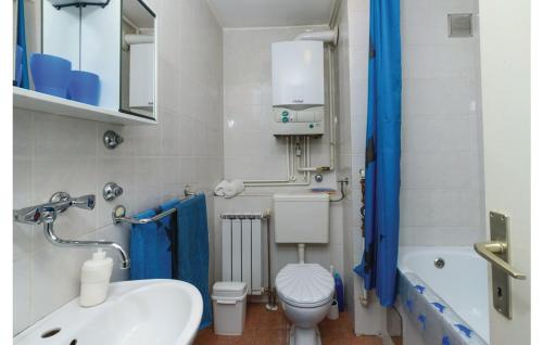 a bathroom with a white toilet and a sink at Apartman Mira in Daruvar