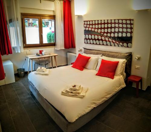 a bedroom with a large bed with red pillows at CIVICO 7 Holiday Rooms in Rome