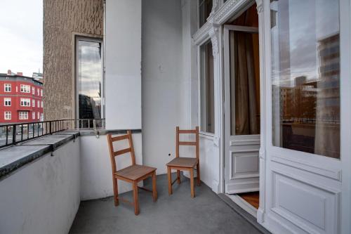 two chairs sitting on the balcony of a building at Hotel Pension Bernstein am Kurfürstendamm in Berlin