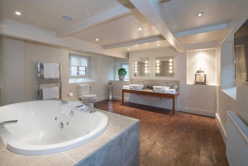 a large bathroom with a large tub and a sink at Russell's in Broadway