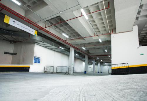 an empty parking lot with chairs in a building at Travel Inn Express Hotels Brás in Sao Paulo