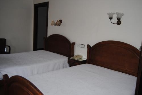 Ένα ή περισσότερα κρεβάτια σε δωμάτιο στο Hotel Peninsular- Porto