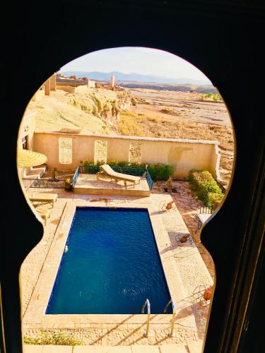a view of a swimming pool from a window at Kasbah Rayane Ait Ben Haddou in Aït Ben Haddou