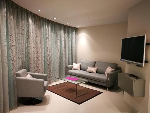 a living room with a couch and a tv at Vista Bella. Apartamentos in Calpe