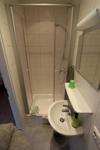 a bathroom with a shower and a sink and a shower at Gästehaus Mea Vota in Braunlage