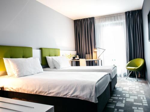 Postel nebo postele na pokoji v ubytování Q Hotel Kraków