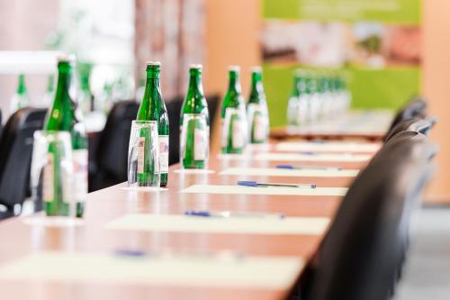 a row of green bottles sitting on a table at Resort Lesní Lázně in Zvánovice