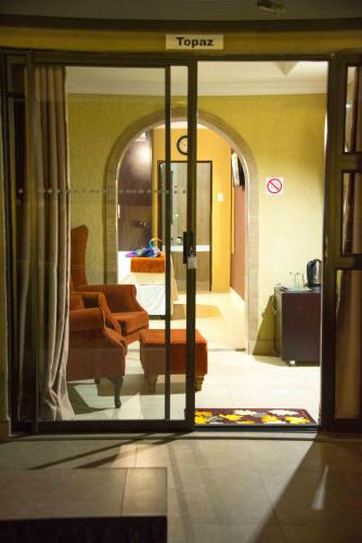 a view of a living room through a glass door at Rekky Signature Guesthouse in Johannesburg