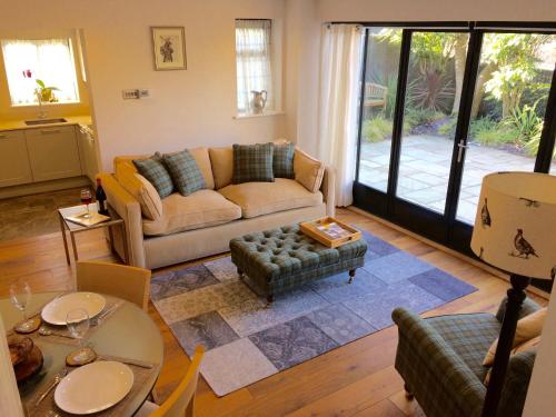 a living room with a couch and a table at Hesmonds Oast Lodge in East Hoathly