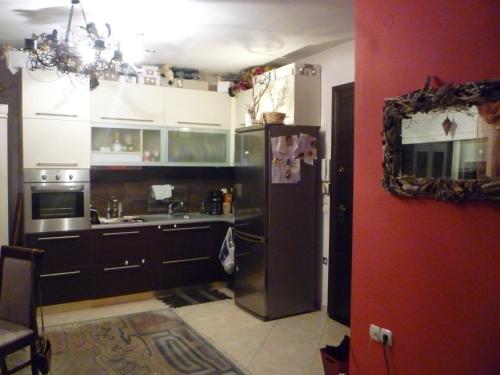 a kitchen with a stainless steel refrigerator in a room at Apartment with Amazing View & parking in Kavala