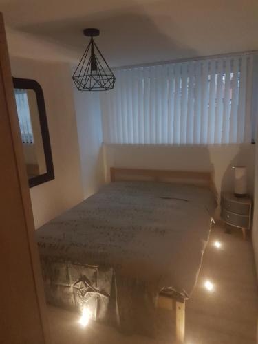 a bedroom with a bed in a room with a window at Ilot Désille in Boulogne-sur-Mer