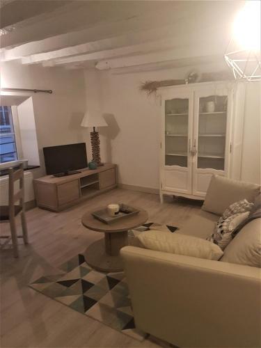 a living room with a couch and a table at Ilot Désille in Boulogne-sur-Mer