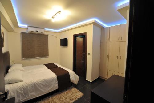 a bedroom with a white bed and a blue light at Casa Di Lusso in Ioannina