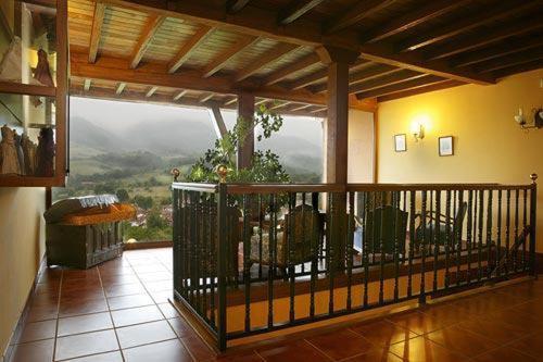 a room with a balcony with a view at Hotel & Spa Villa de Mestas in Cangas de Onís