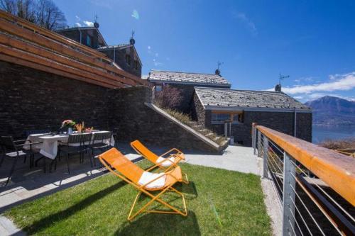 a couple of chairs sitting on a patio with a table at Paradiso del lago in Bellano