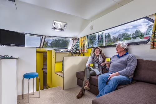 a man and woman sitting in a train car at Domaine du Port Sainte Marie in Maizières-lès-Vic
