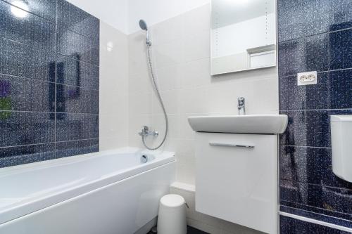 a bathroom with a shower and a toilet and a sink at Urban Retreat Near Metro & Mega Mall in Bucharest