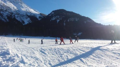 a group of people skiing on a snow covered mountain at Apart Lechtraum in Stanzach
