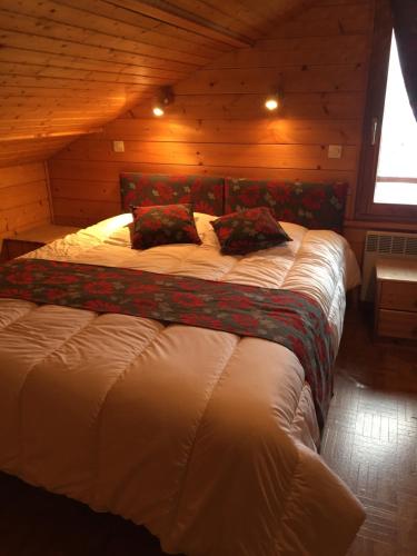 a bedroom with a large bed in a cabin at Les Bruyeres in La Bresse
