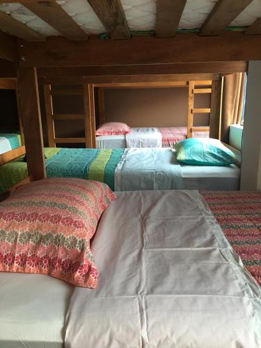 a bedroom with two bunk beds and a bedsheet at Tupac Lima Airport in Lima
