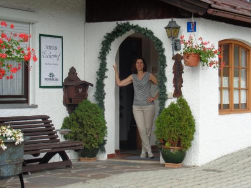 a woman standing in the doorway of a building at Gästehaus Eschenhof in Reit im Winkl