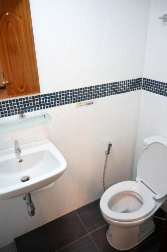 a bathroom with a toilet and a sink at Samsen Sam Place in Bangkok