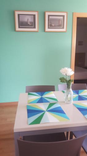 a dining room table with a vase of flowers on it at Hotel Mediterrani Express in Calella