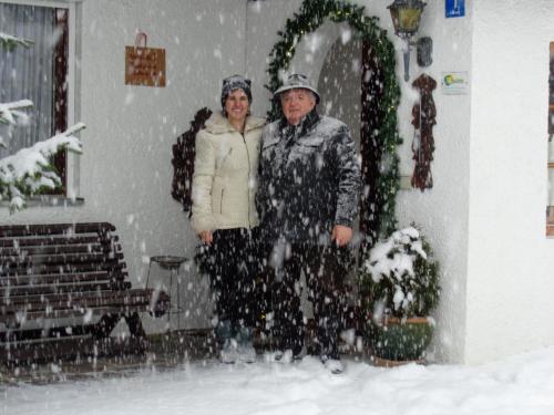a man and a woman standing in the snow at Gästehaus Eschenhof in Reit im Winkl