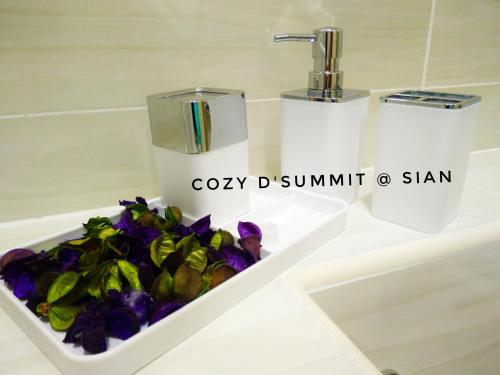 a bathroom sink with a toilet and flowers in it at COZY D'Summit 2 Bedrooms @ 100mbps HIGH SPEED WIFI in Skudai