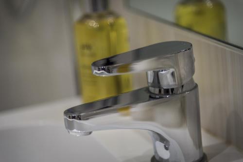 a silver faucet on a sink in a bathroom at The Admiral Rodney Hotel, Horncastle, Lincolnshire - The Coaching Inn Group in Horncastle