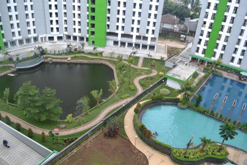an aerial view of a large pool in a city at Green Lake View - Tower E 59 Acuan Laundry Time in Pondokcabe Hilir