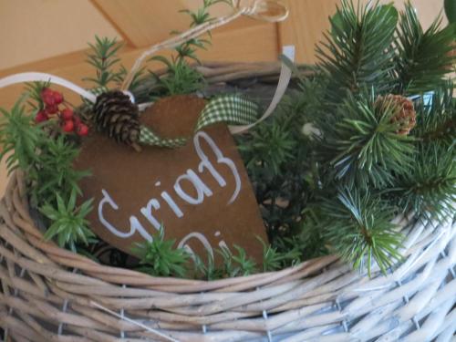 a basket with christmas trees and a sign on it at Pension Marianne - Chiemgau Karte in Inzell